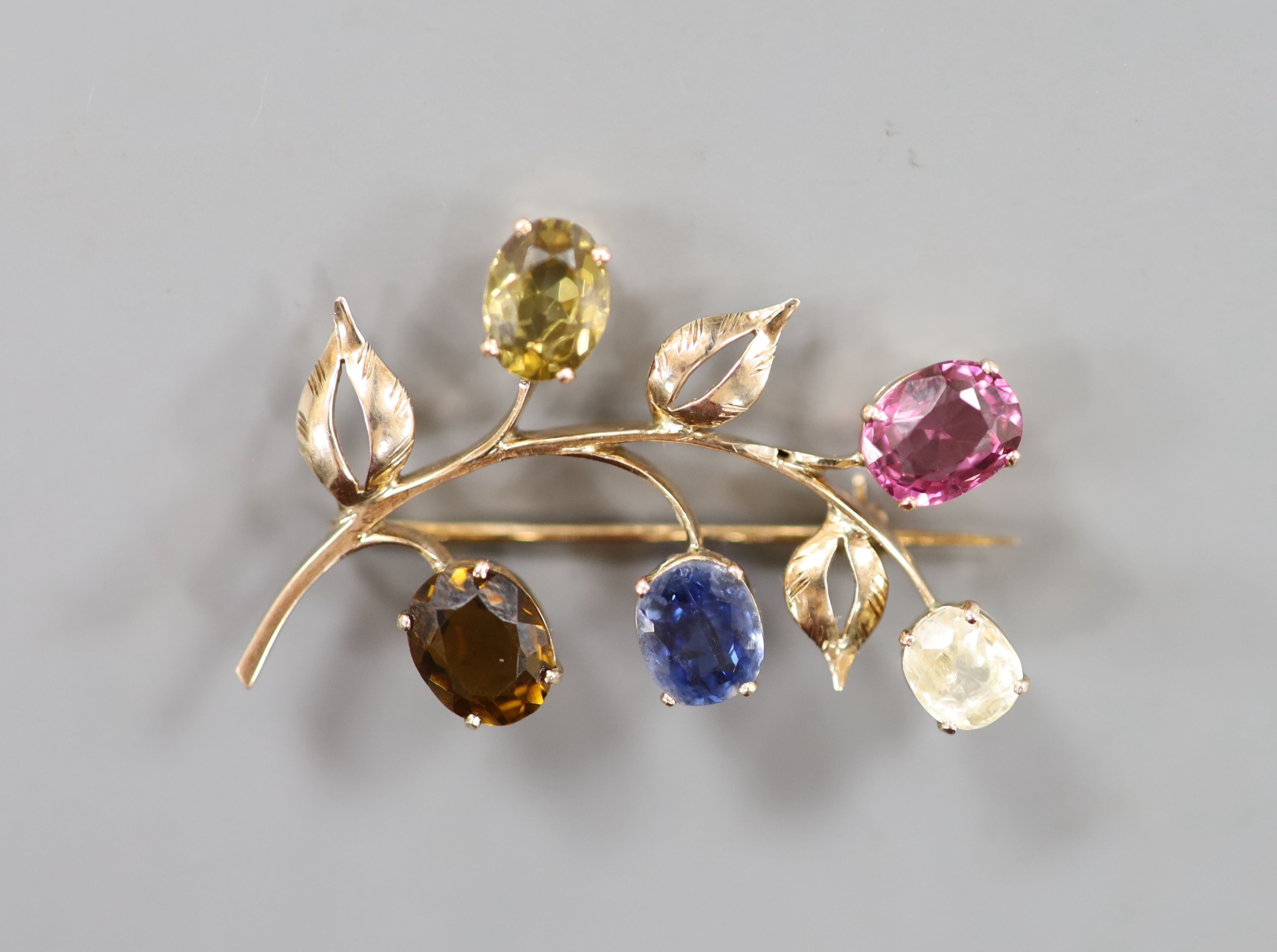A yellow metal and multi gem set (including sapphire, tourmaline and garnet) floral spray brooch, 35mm, gross weight 4.9 grams